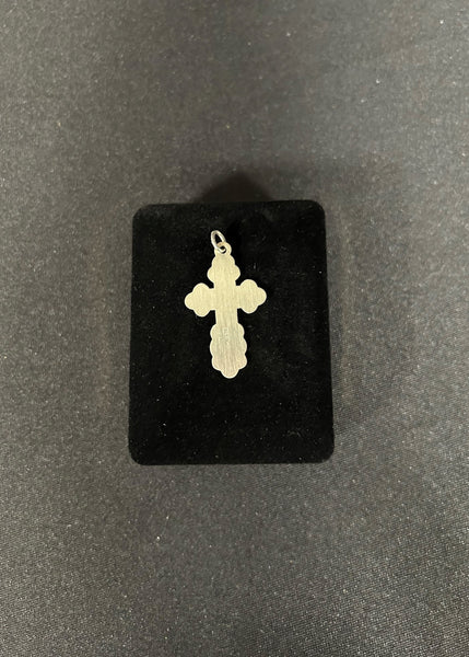 Sterling Silver cross pendant on black fabric background